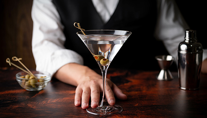 A bartender preparing drinks for guests