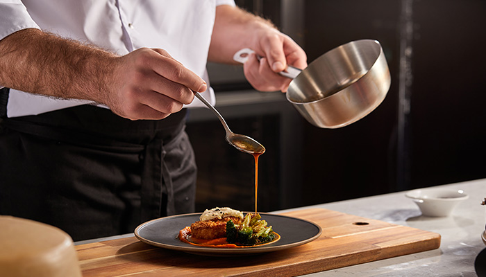 Private chef preparing a plated meal