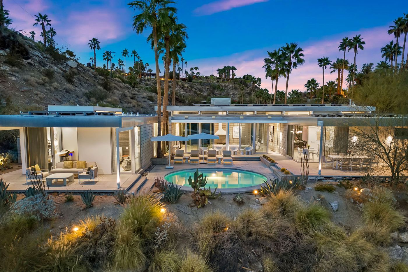 Glass Haus in Palm Springs, with its circular pool, glass walls and desert hillside setting